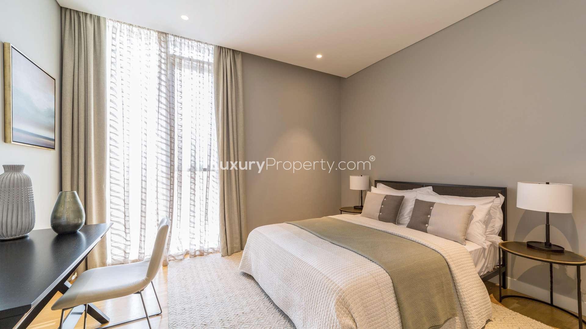Modern bedroom in Bluewaters apartment, featuring stylish decor and workspace. LP0226 for sale