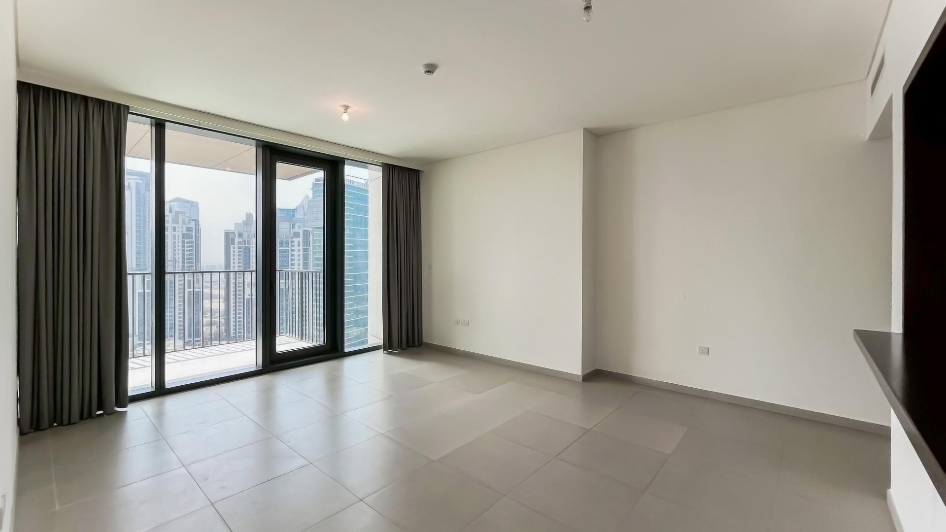 Spacious living area with balcony view in Downtown Dubai apartment, BLVD Heights