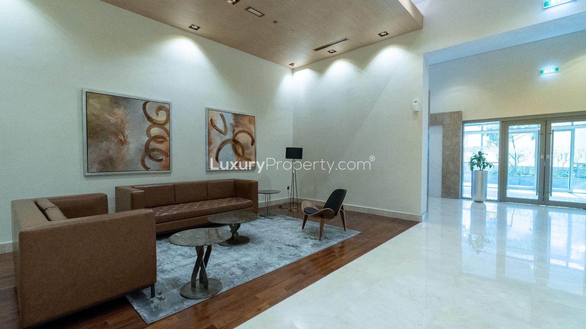 "Modern high-rise apartment building exterior in Downtown Dubai, available for sale, LP11398.",Modern lounge area in spacious Downtown Dubai 1-bedroom apartment for sale, LP11398