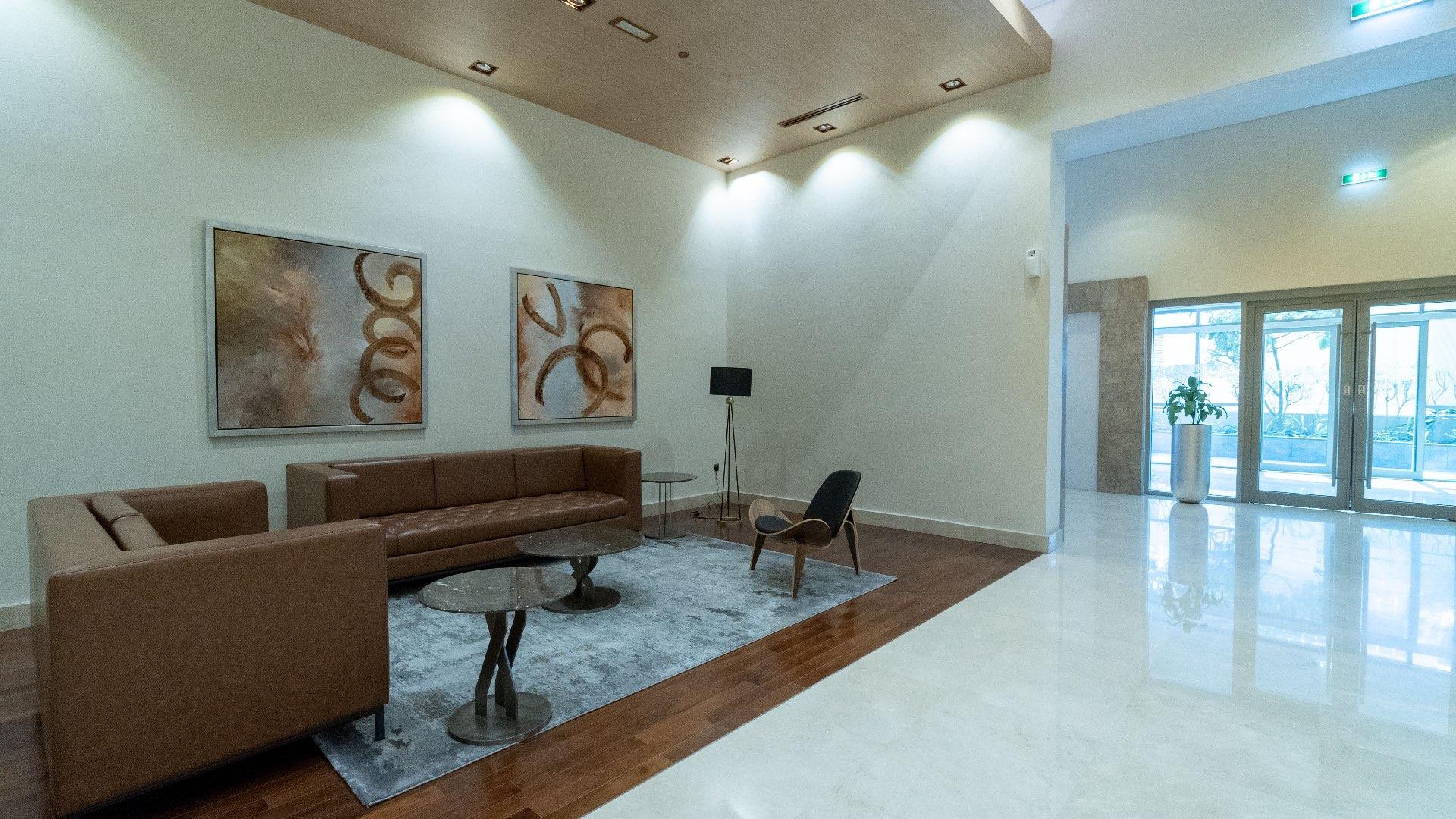 "Modern high-rise apartment building exterior in Downtown Dubai, available for sale, LP11398.",Modern lounge area in spacious Downtown Dubai 1-bedroom apartment for sale, LP11398