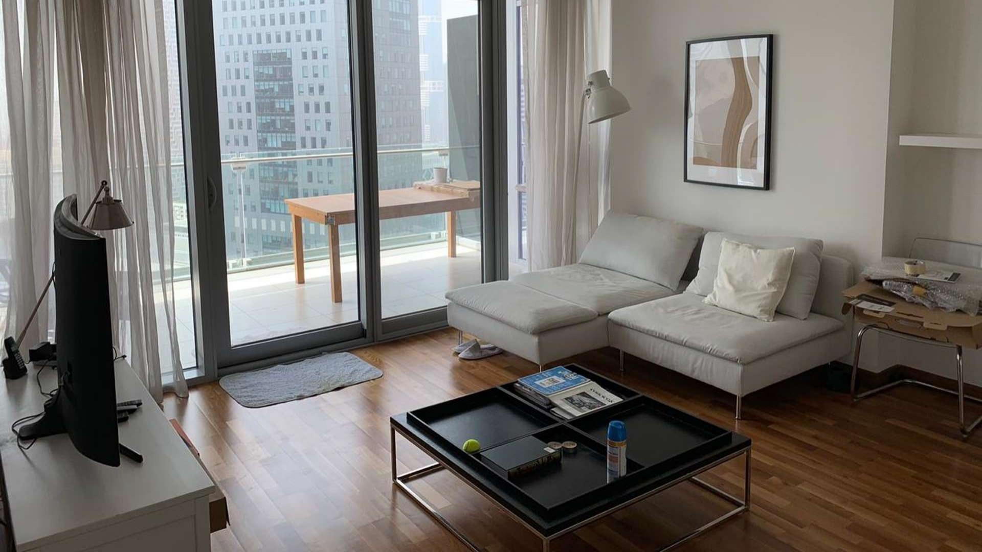 Upgraded apartment living room with DIFC skyline view, Burj Daman, for sale