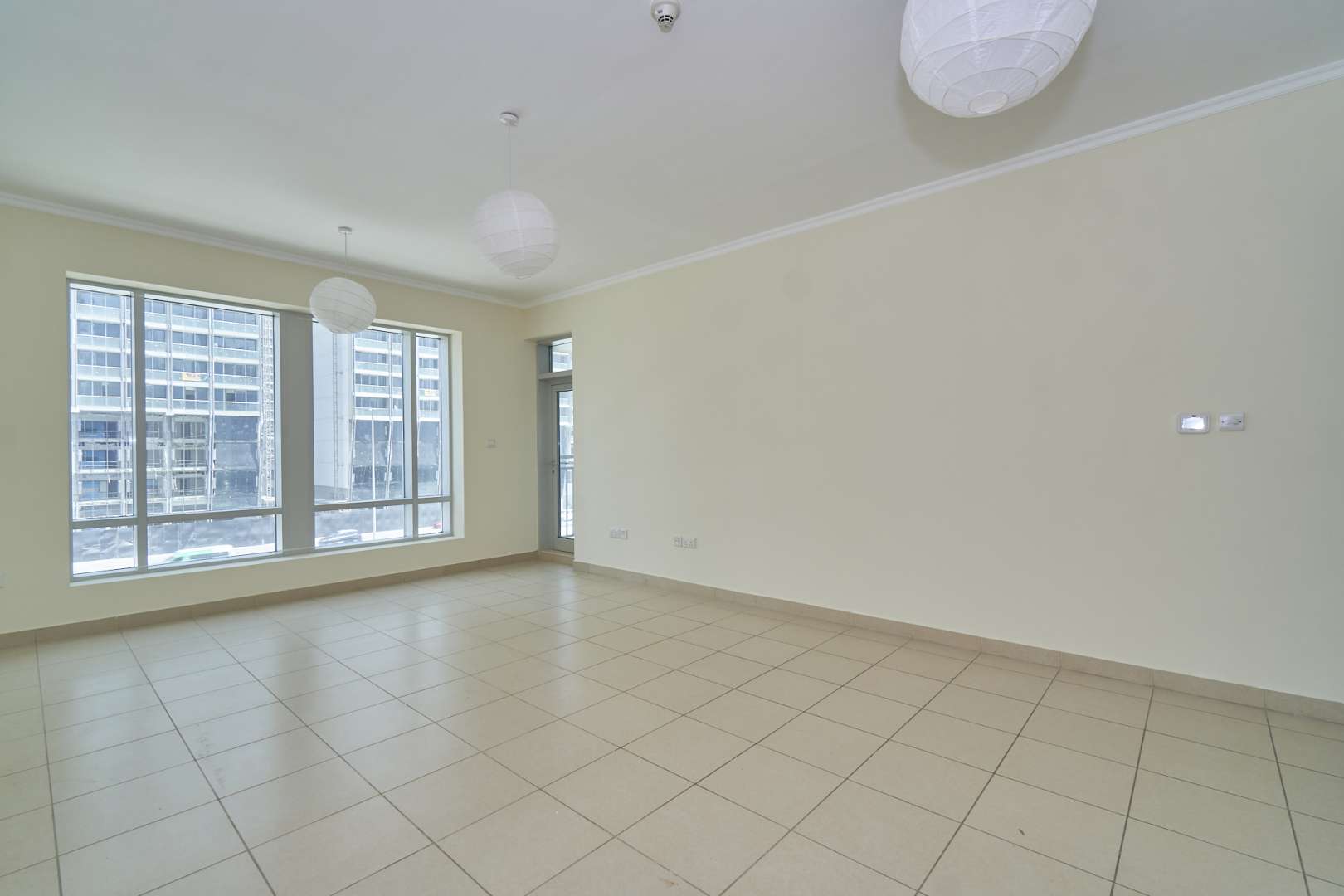 Spacious living room in one-bedroom apartment, Burj Views, Downtown Dubai, tiled floors, large windows