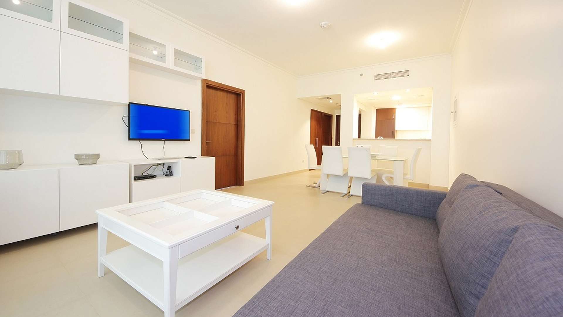 Furnished bedroom in Burj Vista apartment, Downtown Dubai, with wooden wardrobe and dresser