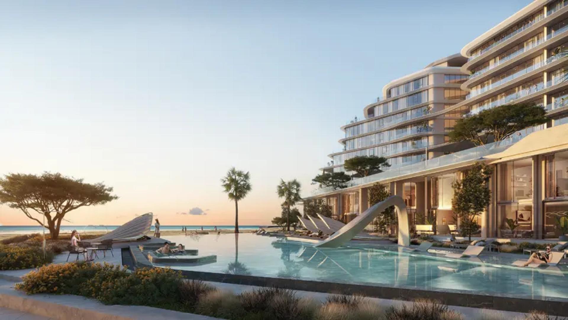 Modern Porto Playa apartments on Hayat Island with beachfront and palm trees, Mina al Arab