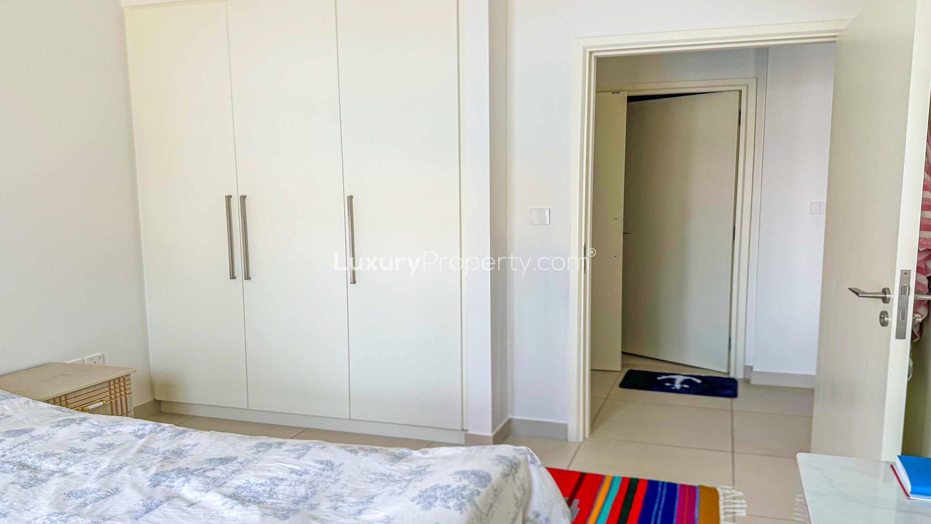 Alt text: "Bright bedroom with built-in wardrobe in Burj Crown apartment, Downtown Dubai, for sale.","Iconic pool view from Burj Crown apartment, Downtown Dubai, for sale, LP45797.","Downtown Dubai apartment view, overlooking pool and skyline from Burj Crown window.",Alt text: "Downtown Dubai apartment view with pool and skyline, Burj Crown sub-community."