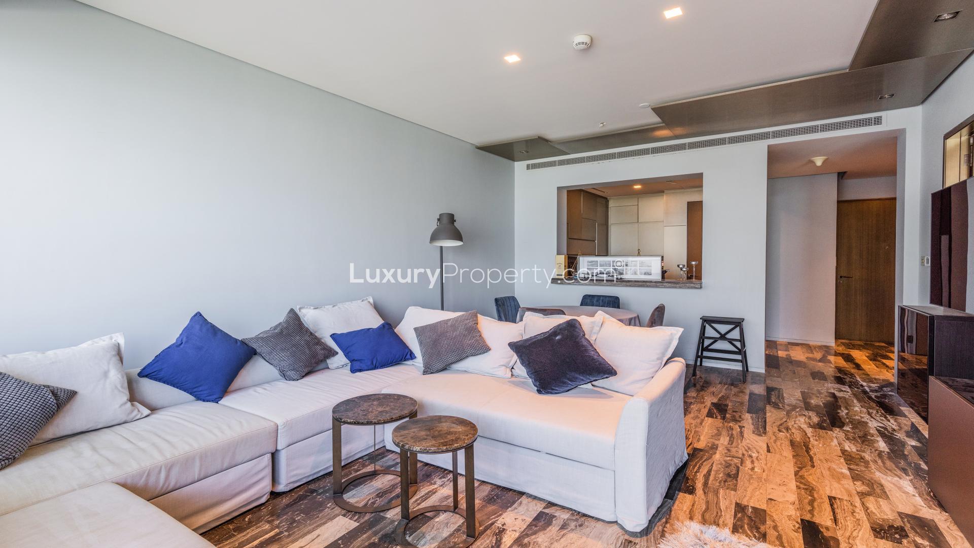 Modern living room in Dubai Marina apartment, featuring cozy seating and stylish decor