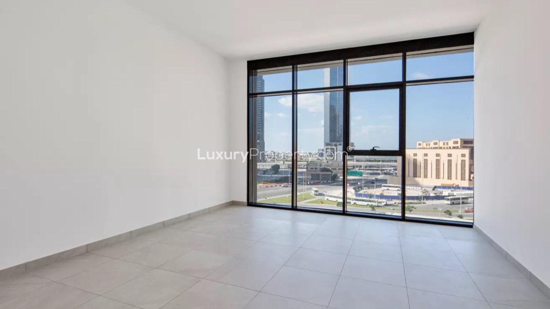 Empty apartment bedroom with large window view in DT1, Downtown Dubai