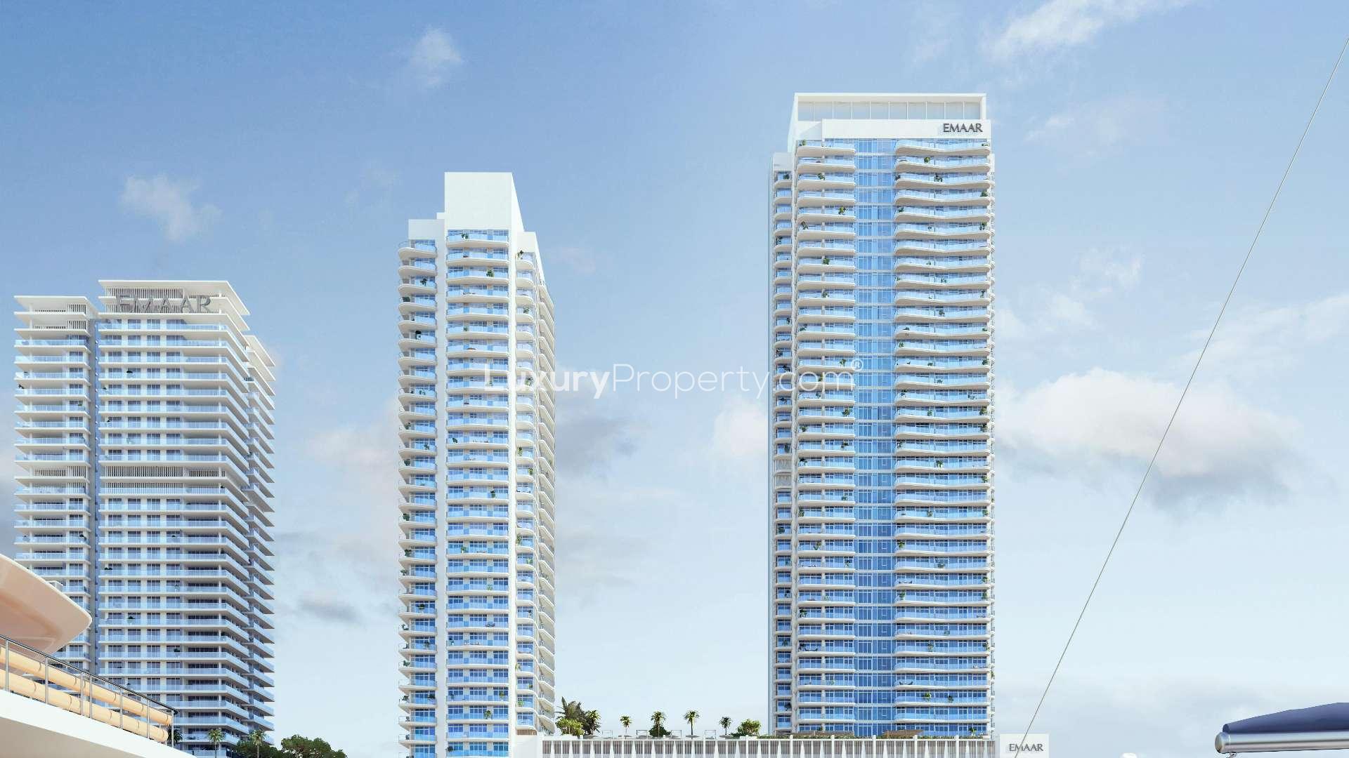 Luxurious poolside view overlooking Dubai skyline at Emaar Beachfront apartment for sale