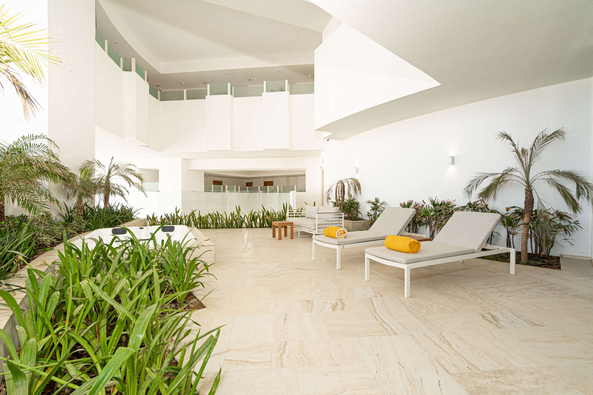 Modern living room in 1-bedroom apartment, Jumeirah Village Circle, featuring sleek decor and greenery