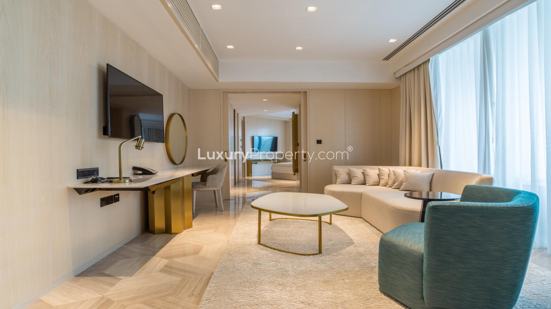 Modern living room in 1-bedroom apartment, Palm Jumeirah, featuring elegant decor and natural light