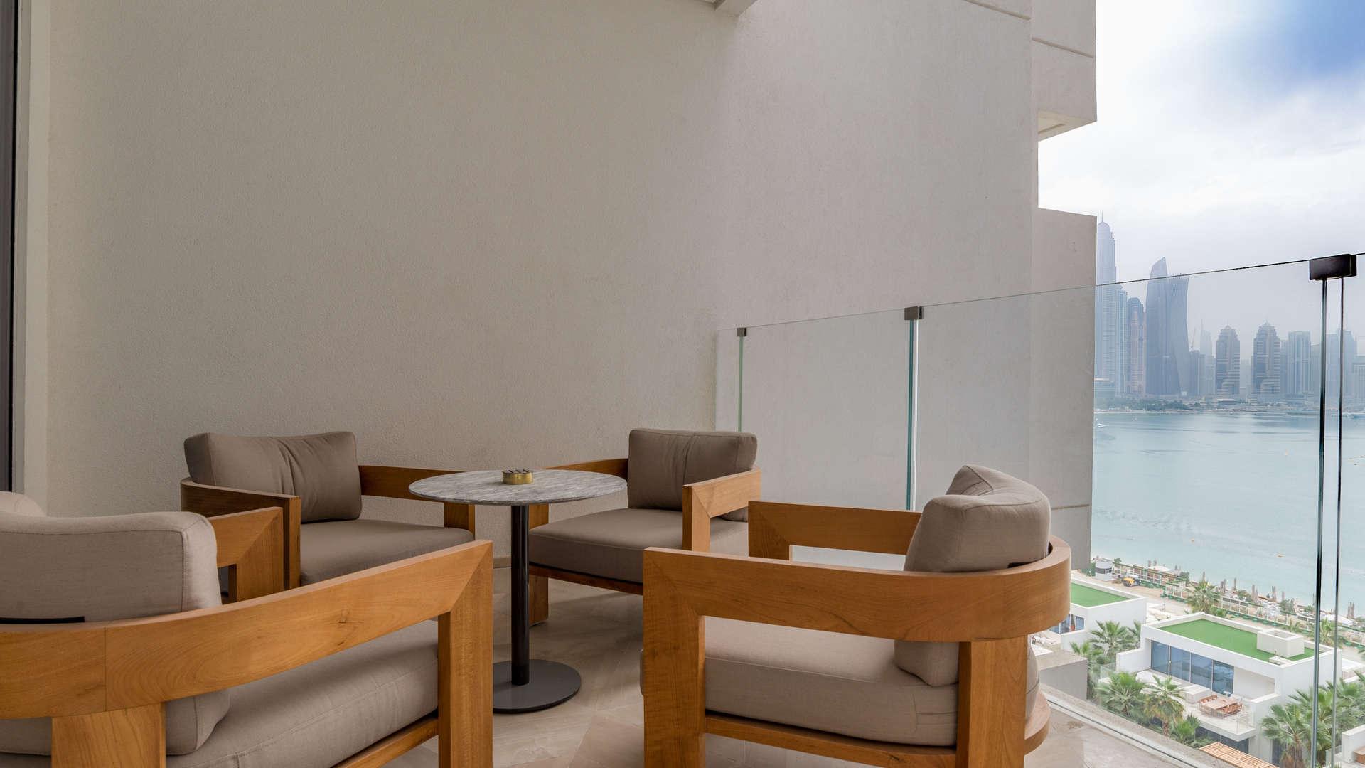 Modern dining area with city views in Five Palm Jumeirah waterfront apartment for sale