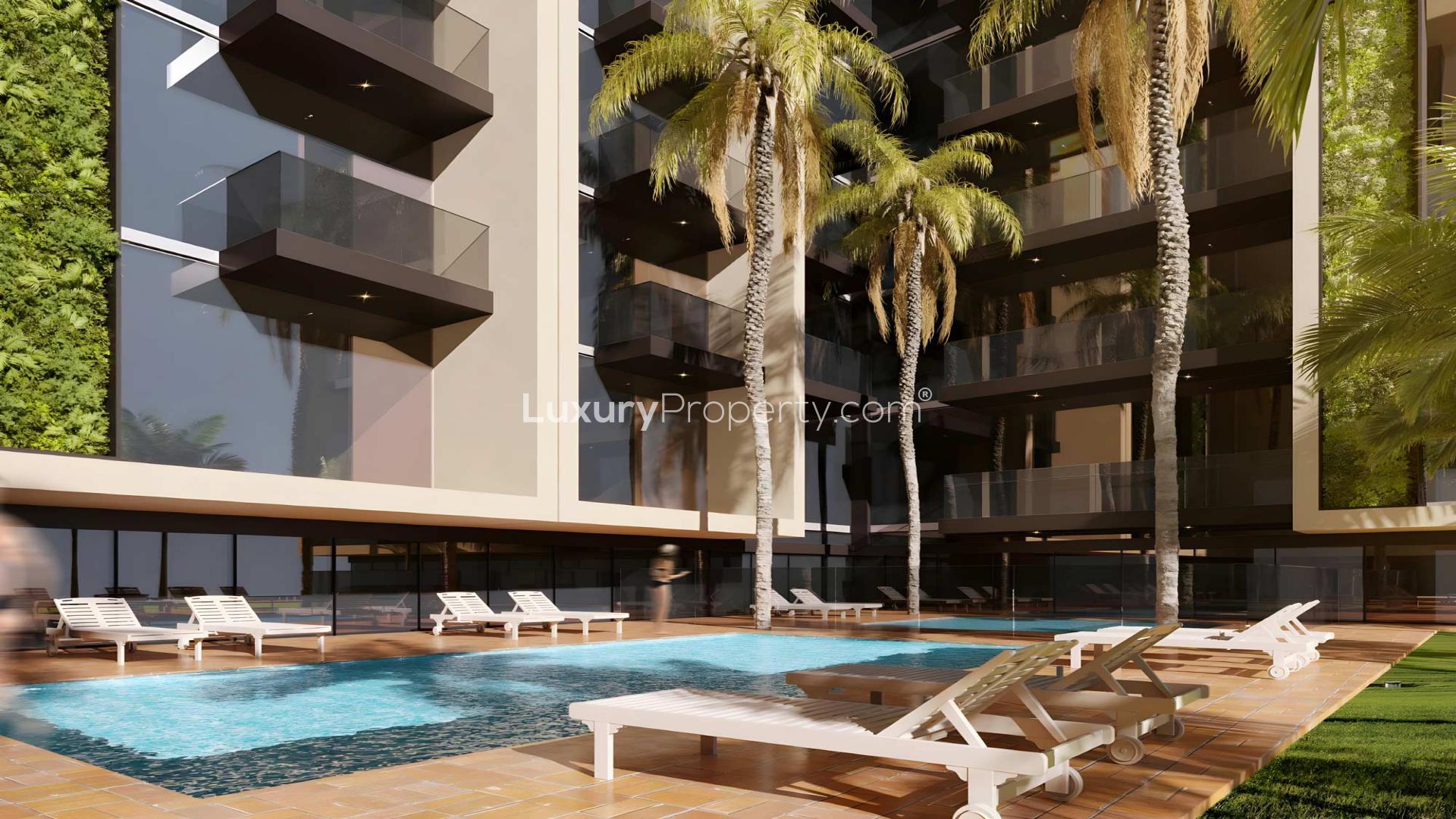 High-floor Neva Residences apartment exterior in Jumeirah Village Circle, Dubai skyline view