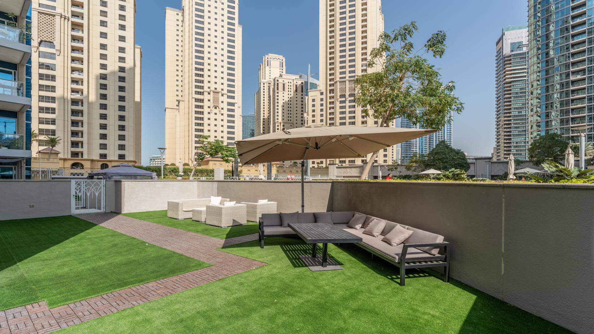 Upgraded furnished living room with large terrace view in Marina Promenade apartment, Dubai Marina