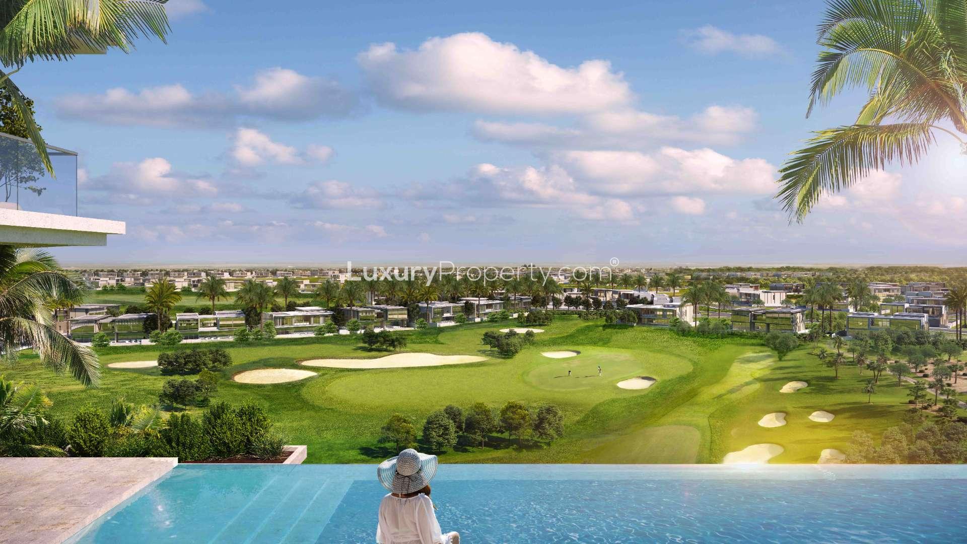 High-floor apartment balcony view of Dubai Hills Estate golf course at sunset