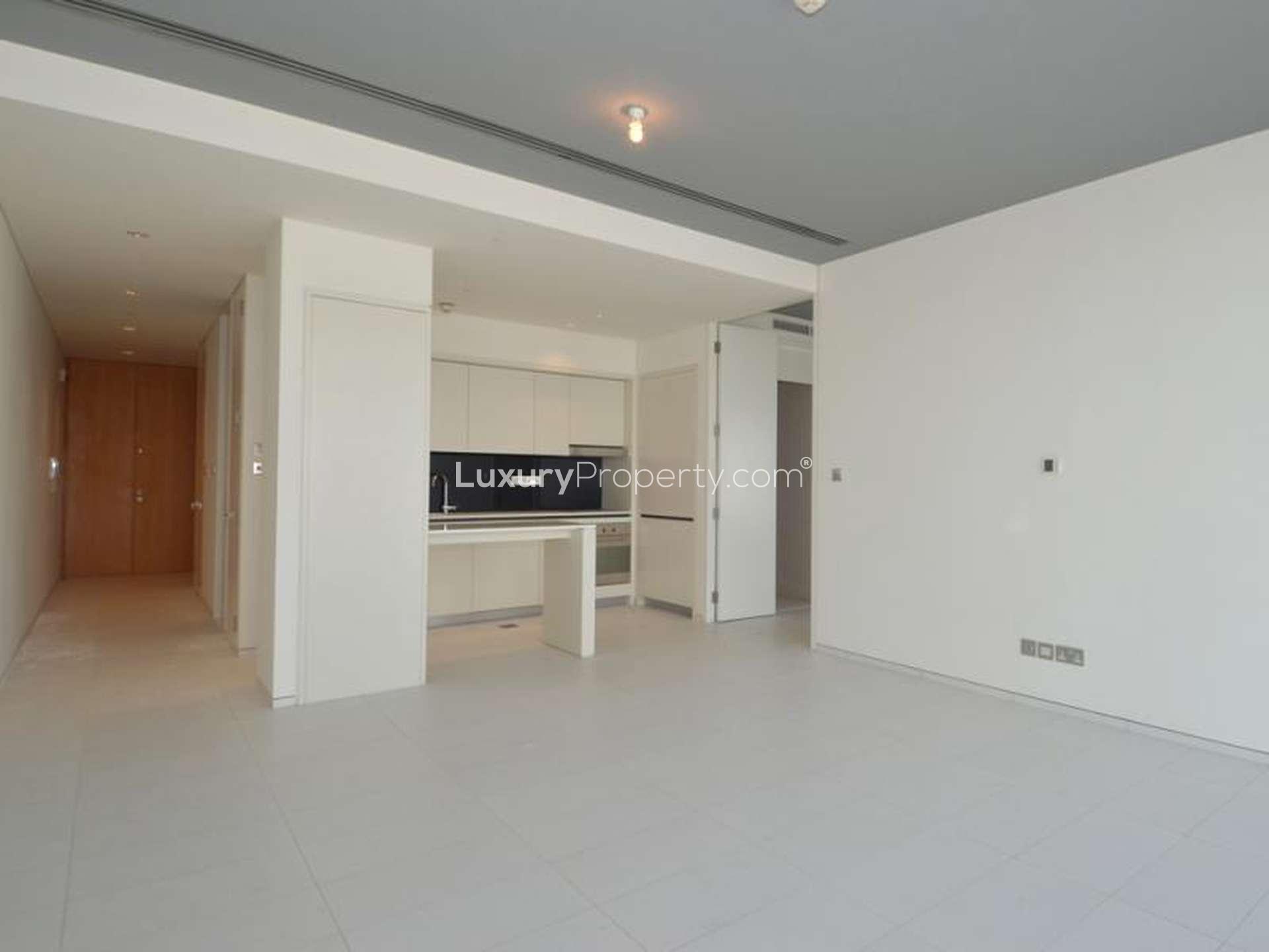 Empty luxury apartment with large window offering stunning downtown views in Index Tower, DIFC
