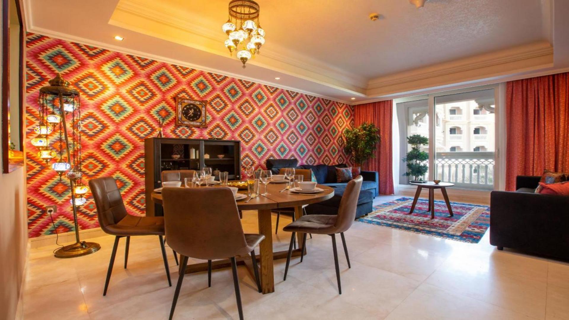Palm Jumeirah apartment view with lush greenery and ocean backdrop, Grandeur Residences