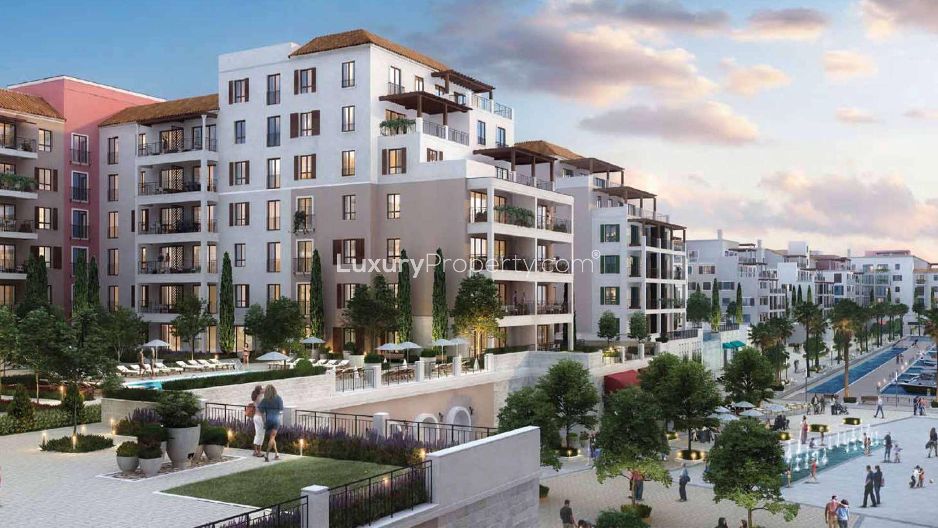 Elegant apartment gym with modern equipment, full-height windows, and city views in La Mer