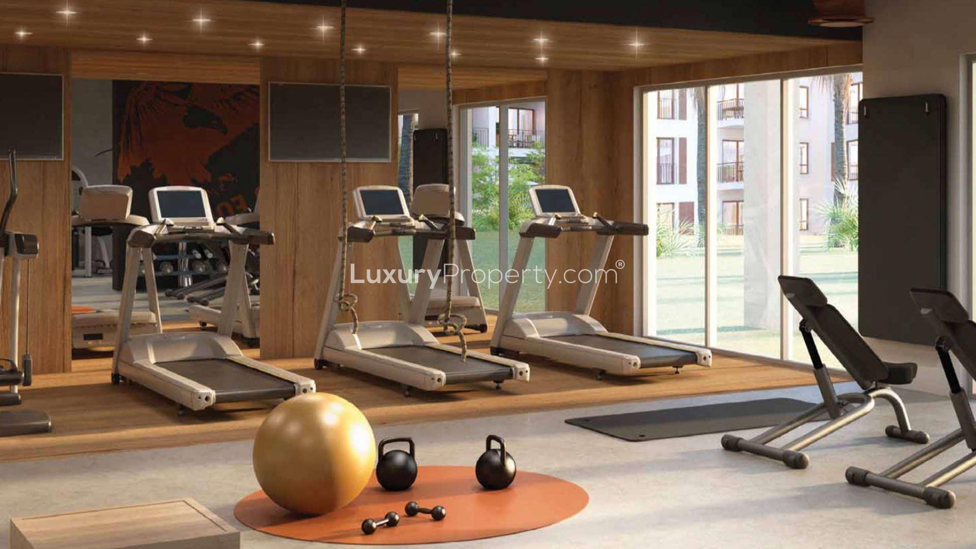 Elegant La Mer apartment building with outdoor cafe, lush greenery, and city views