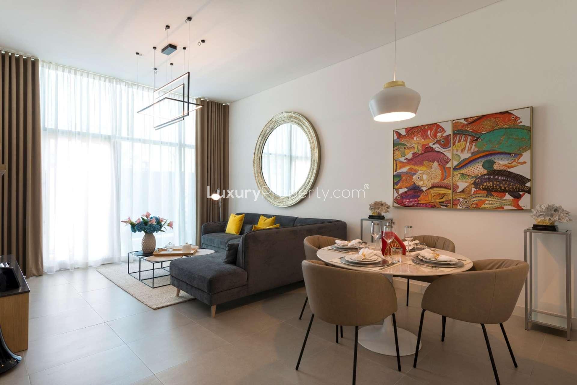 Elegant living and dining area in Jumeirah Village Circle apartment with modern furnishings