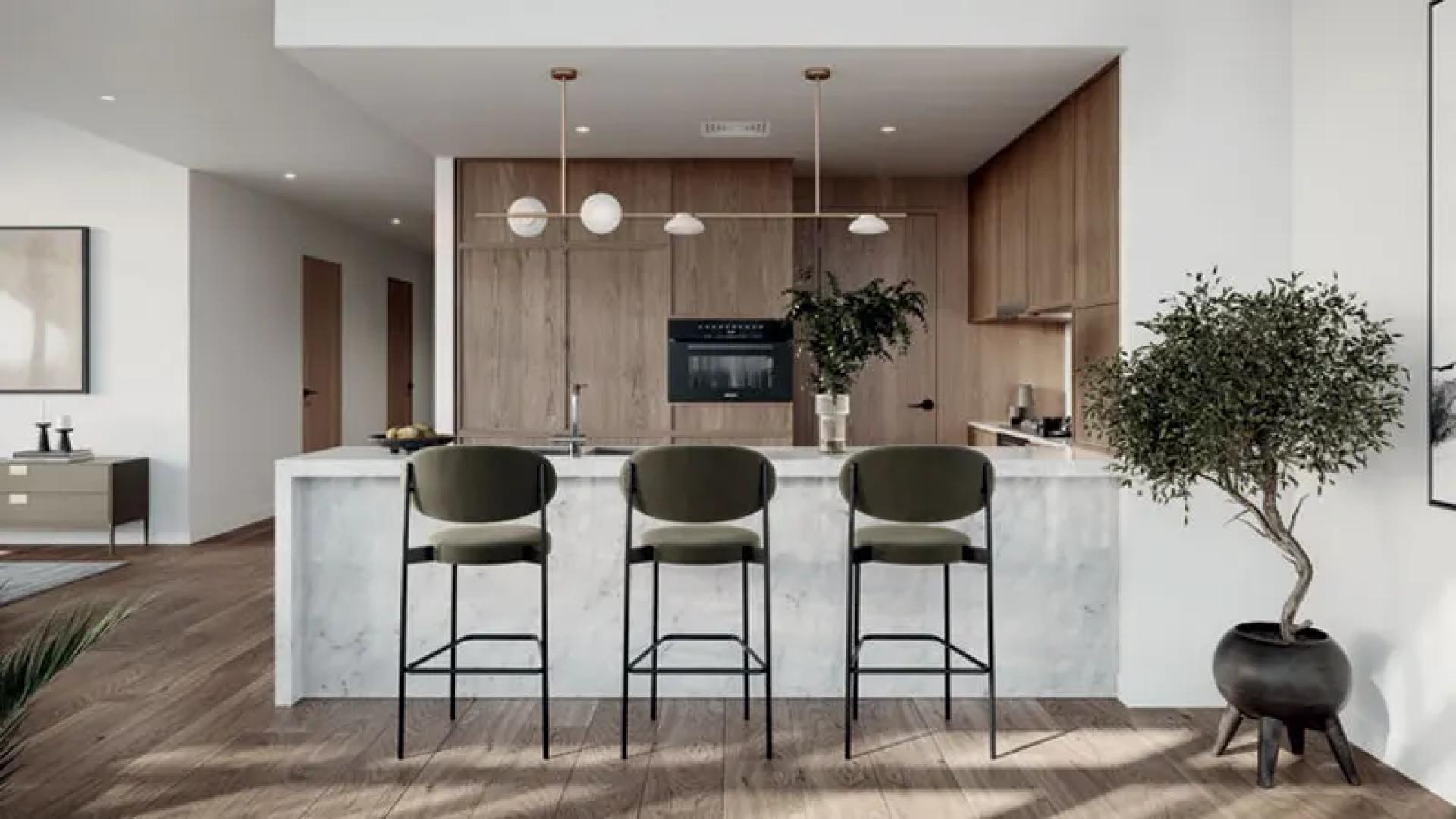 High-floor Dubai Hills Estate apartment living room with modern decor and pool view