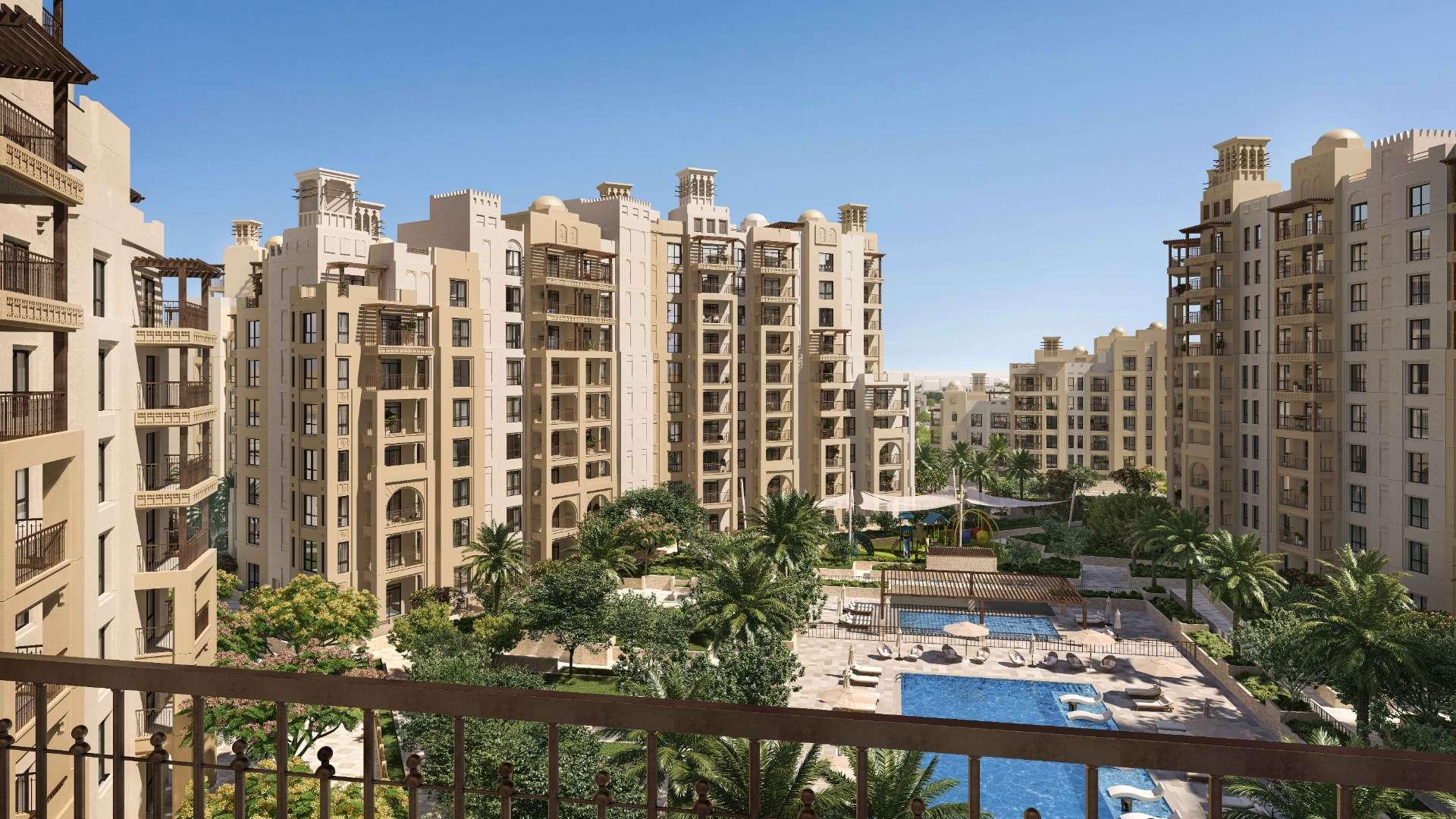Alt text: "Madinat Jumeirah Living apartment complex with pool view in Umm Suqeim community.",Lovely one-bedroom apartment living area in Madinat Jumeirah Living, Umm Suqeim, for sale