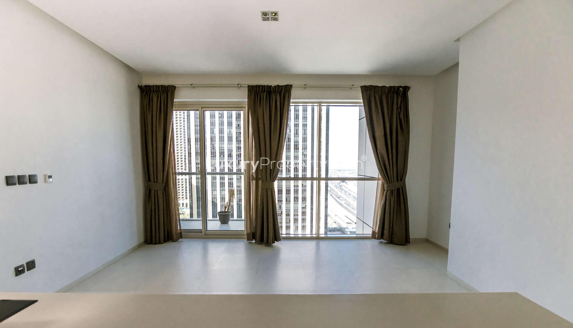 "Bright Dubai Marina apartment with city views, spacious windows, West Avenue, for sale.",Modern living room with large windows in Dubai Marina apartment, West Avenue