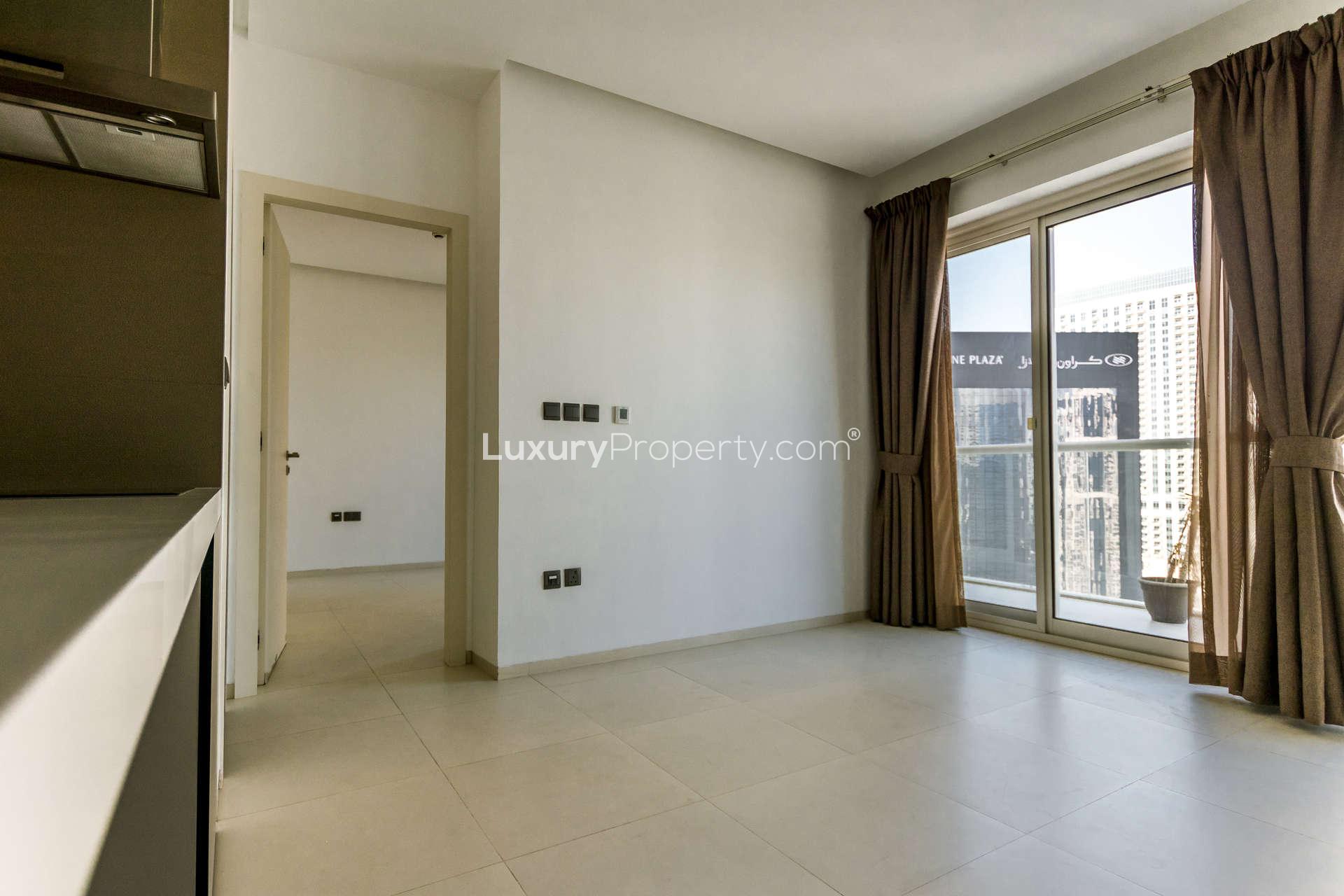 Modern living room in Dubai Marina apartment with city view and balcony access