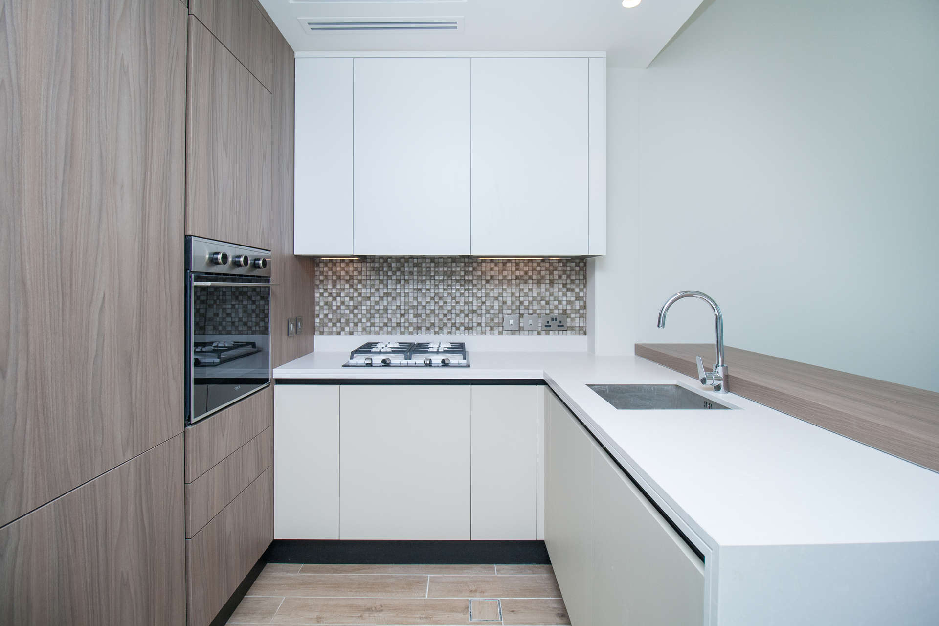 Modern kitchen in one-bedroom apartment at Marina Gate, Dubai Marina, featuring sleek cabinetry