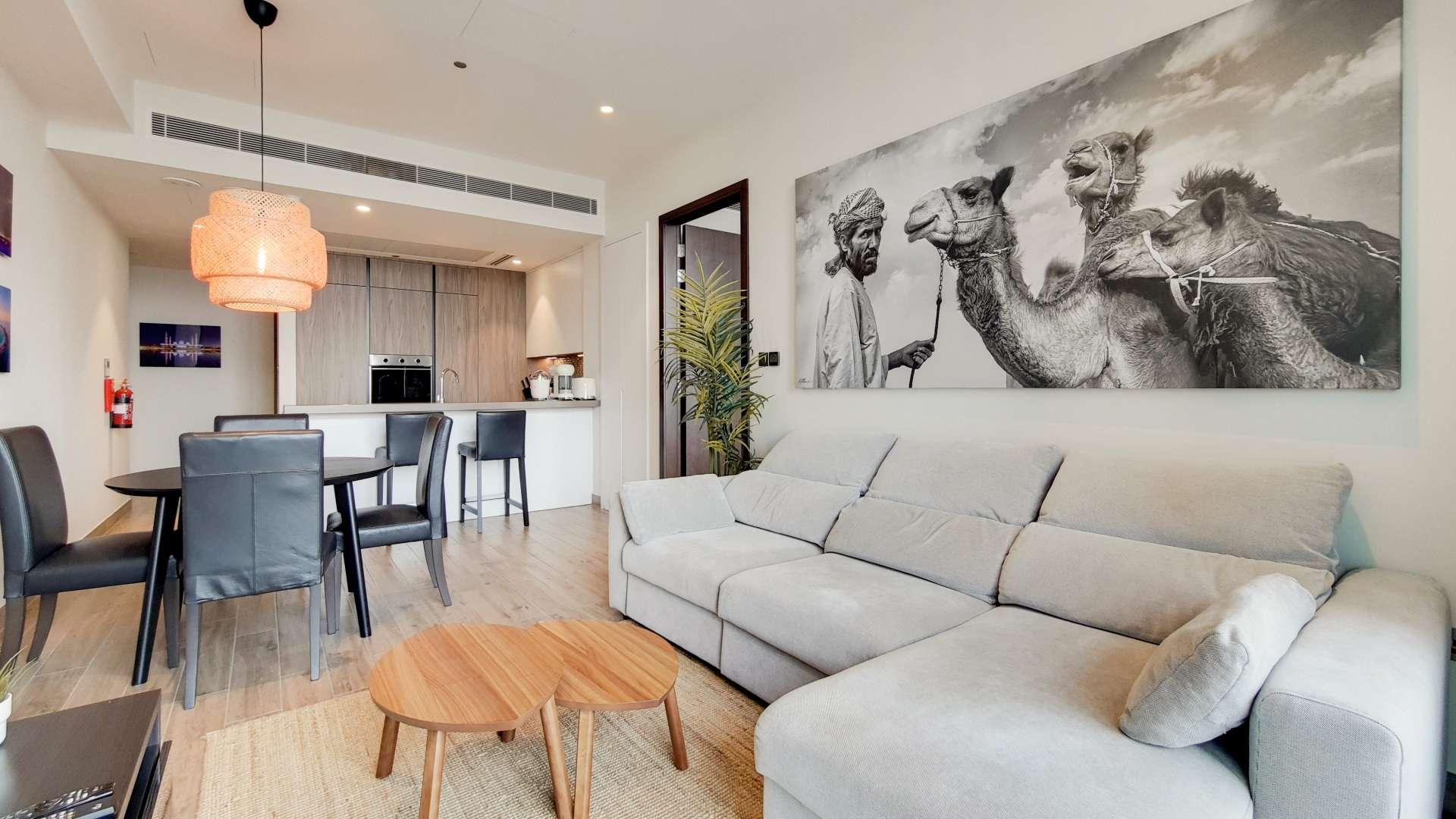 High-floor apartment living room with marina views, modern decor, and dining area in Marina Gate