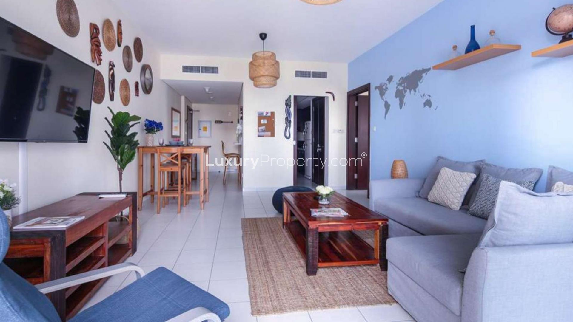 Elegant bedroom reflection in round mirror, Marina Tower apartment, Dubai Marina