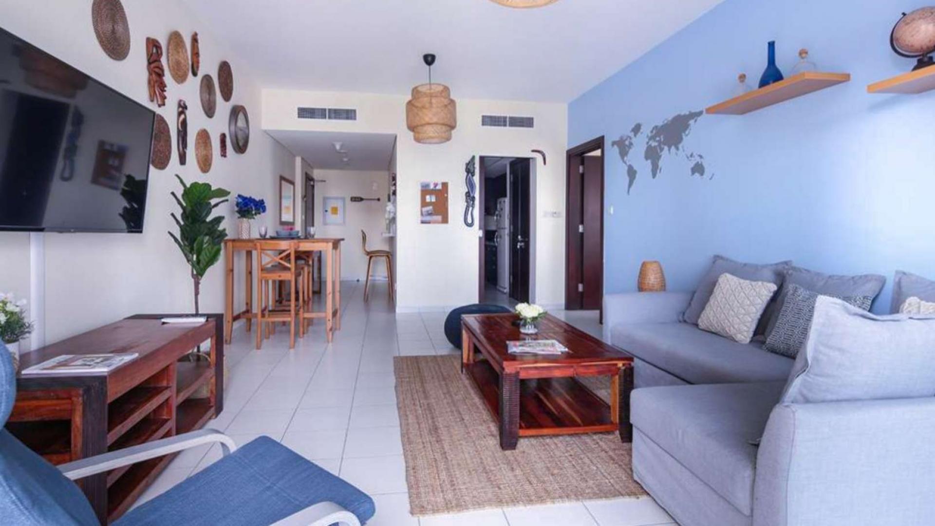 Elegant bedroom reflection in round mirror, Marina Tower apartment, Dubai Marina