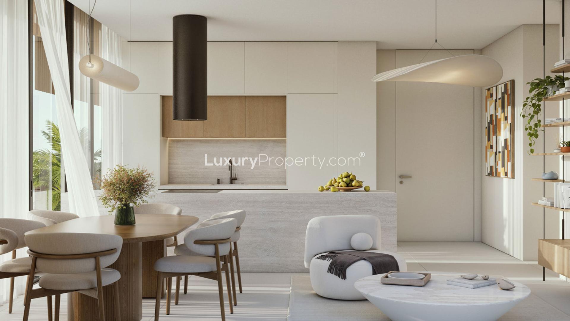 Modern kitchen and dining area in Jumeirah Garden City apartment, featuring city views