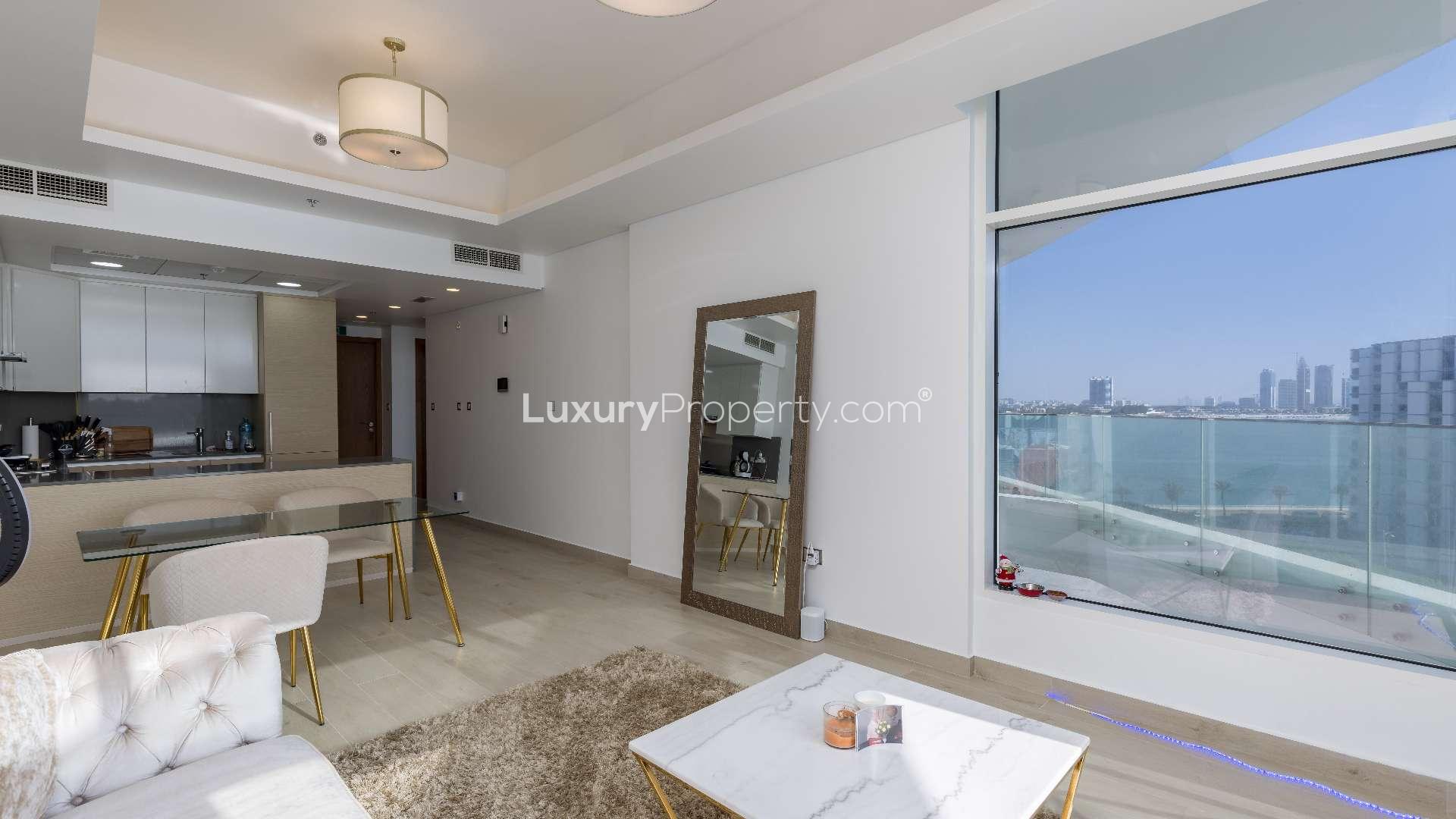 Palm Jumeirah apartment living room with sea view, modern decor, and balcony access