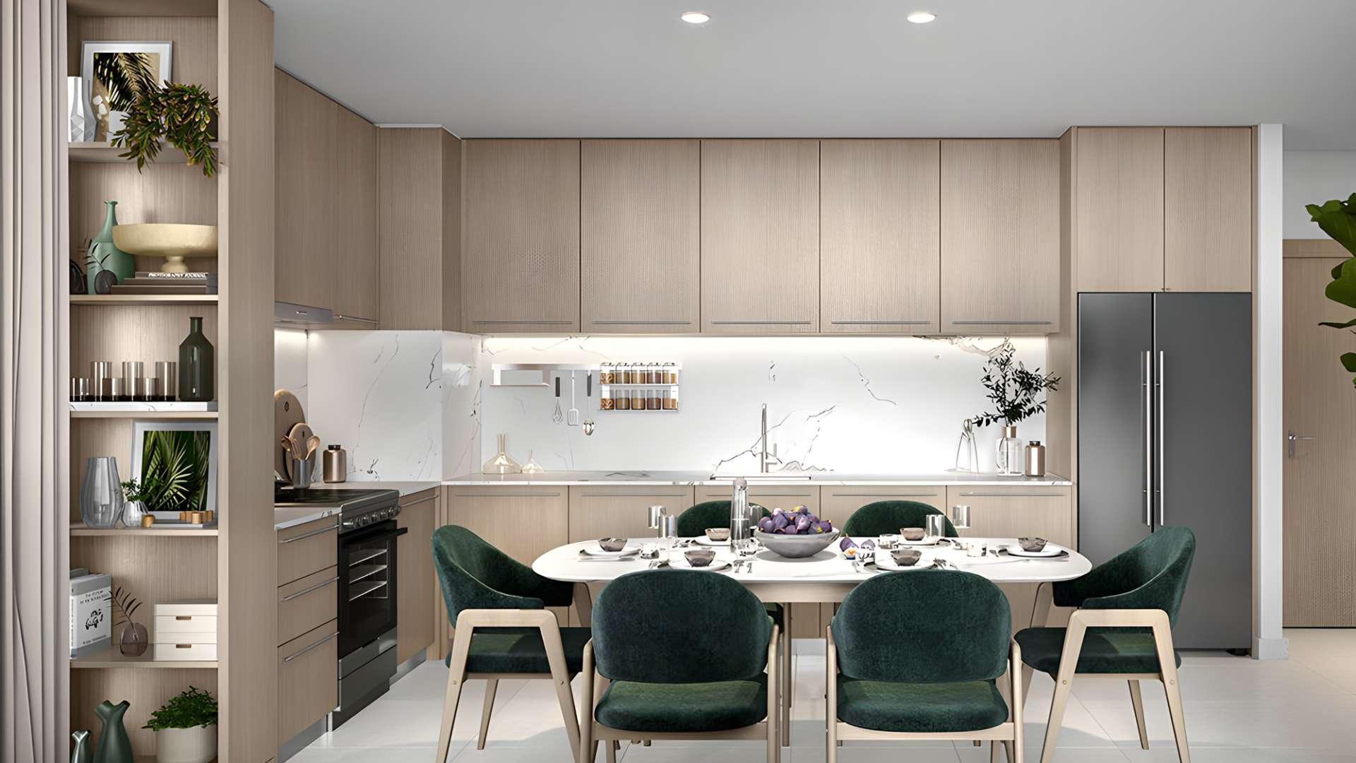 "Luxury park-facing apartment view at sunset in Dubai Hills Estate, Elvira, Park Heights.",Modern kitchen and dining area in Elvira apartment, Dubai Hills Estate, Park Heights