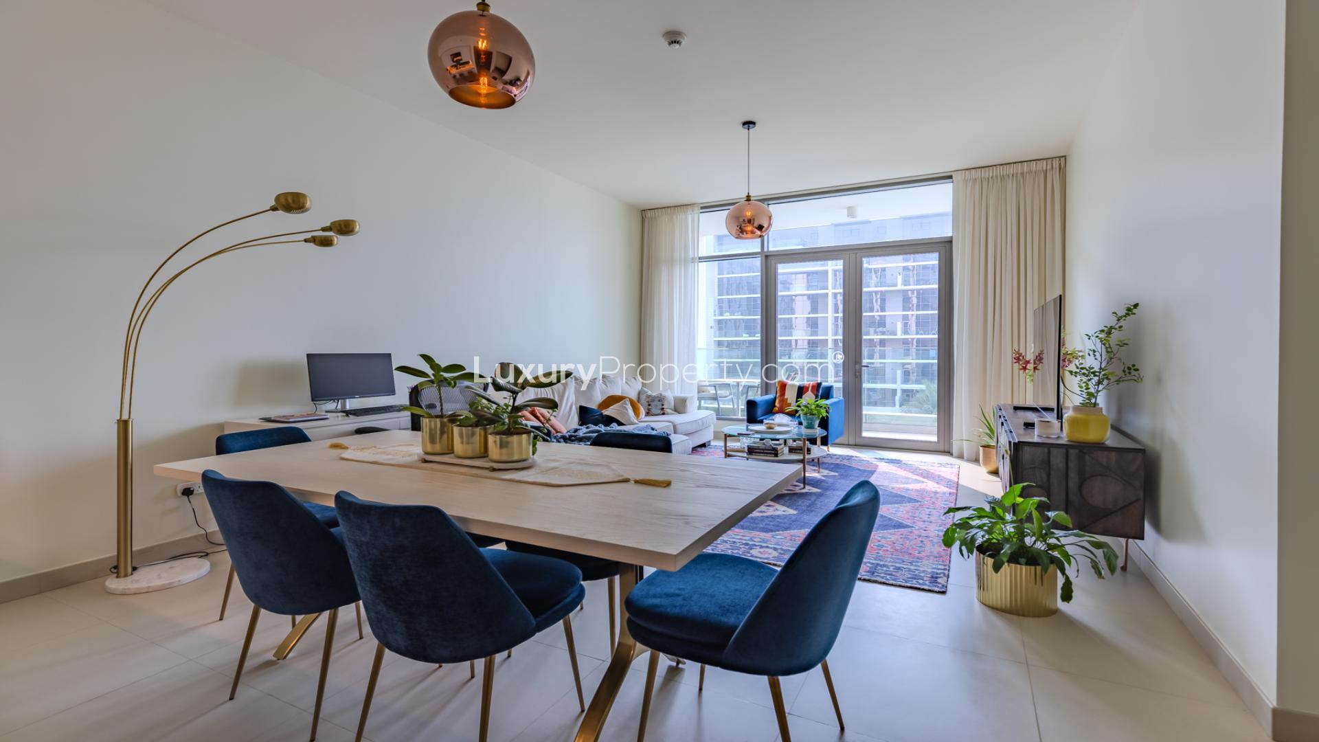 Modern living room in Dubai Hills Estate apartment with stylish decor and open kitchen