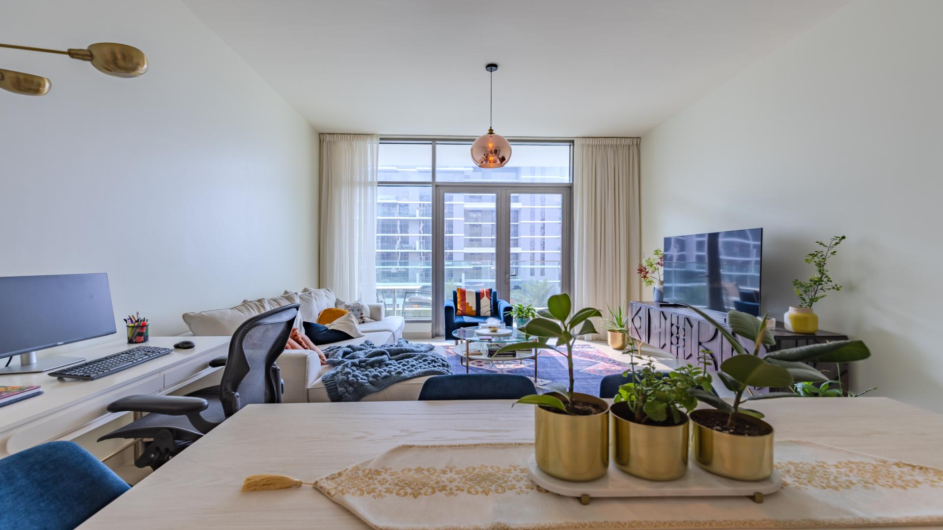 Modern living room in Dubai Hills Estate apartment, featuring stylish decor and large windows