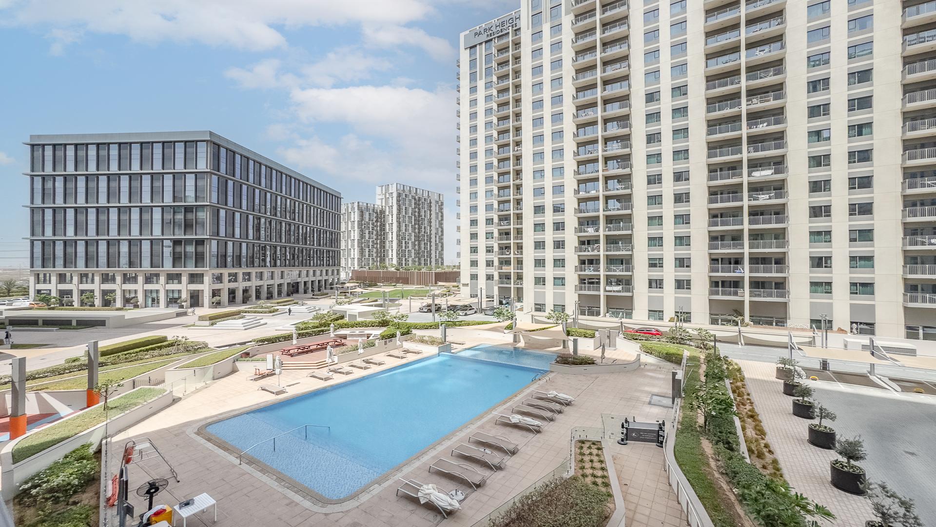 Empty living room with tiled floor and kitchen in Park Heights 1, Dubai Hills Estate