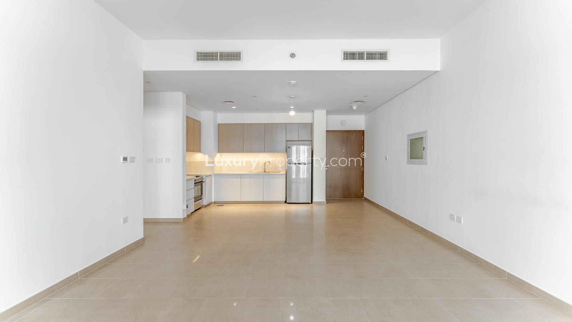 Empty living room with balcony view in Park Heights 1-bedroom apartment, Dubai Hills Estate