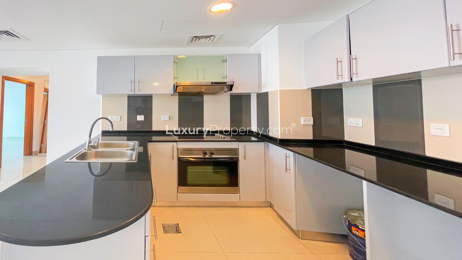 Modern kitchen in Ocean Heights one-bedroom apartment, Dubai Marina, featuring sleek countertops and cabinetry