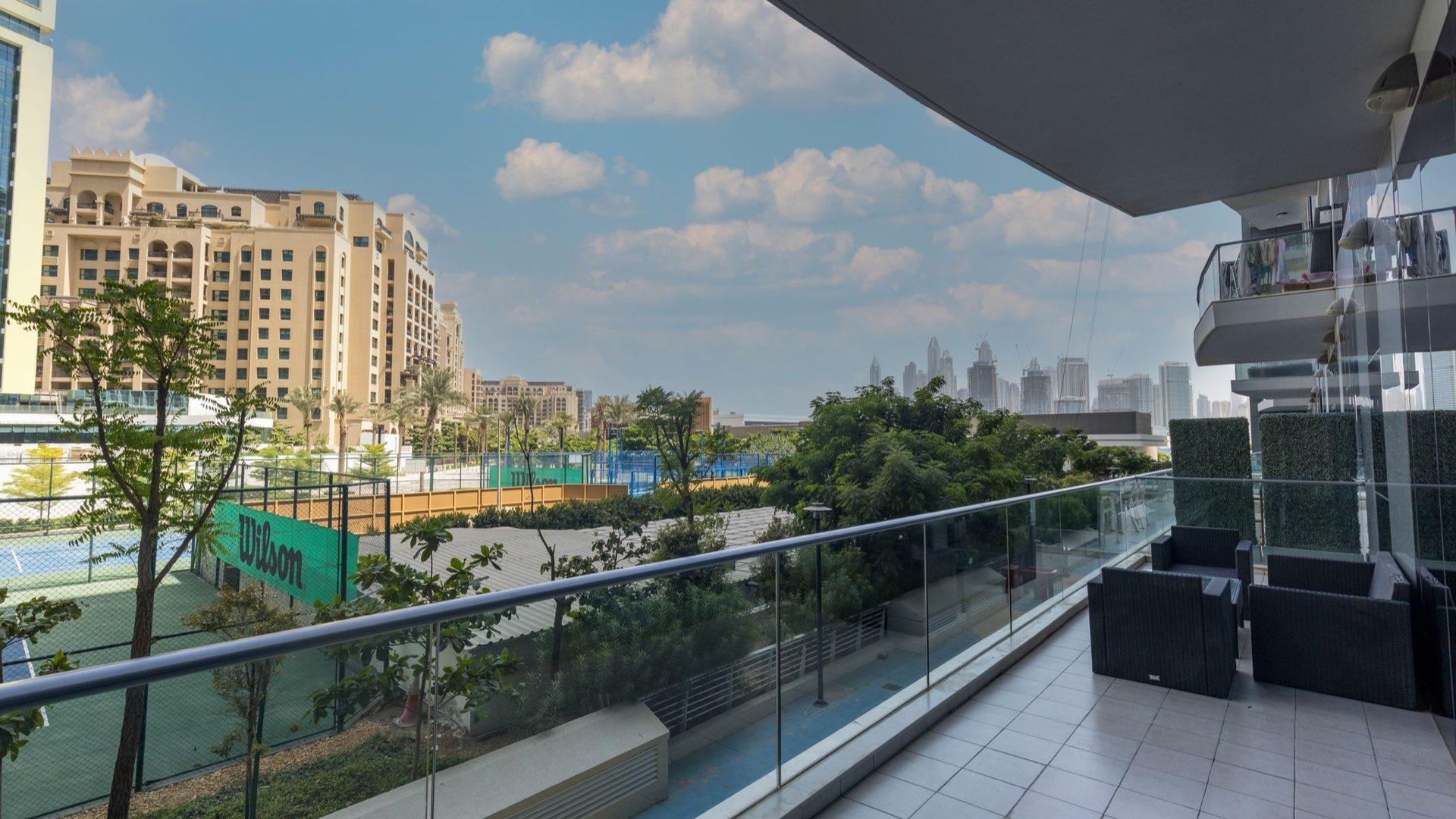 Luxurious bedroom in Palm Jumeirah apartment with elegant four-poster bed and cozy decor