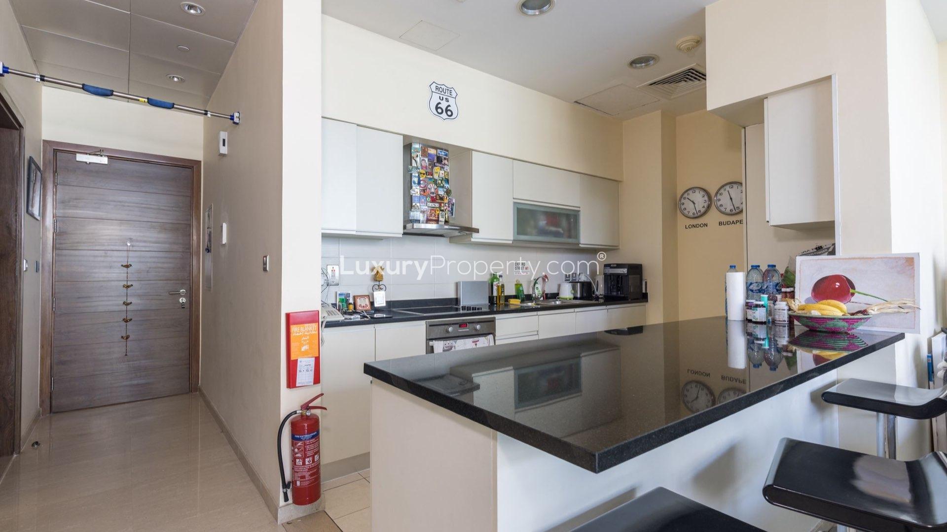 Balcony view overlooking tennis court and skyline at Palm Jumeirah Oceana apartment