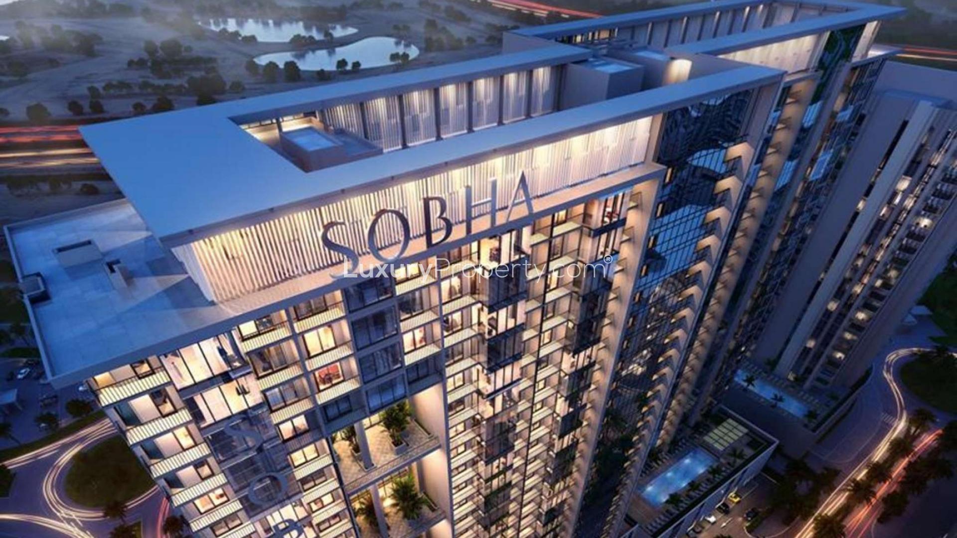 Aerial view of Sobha Hartland's One Park Avenue apartment building at sunset