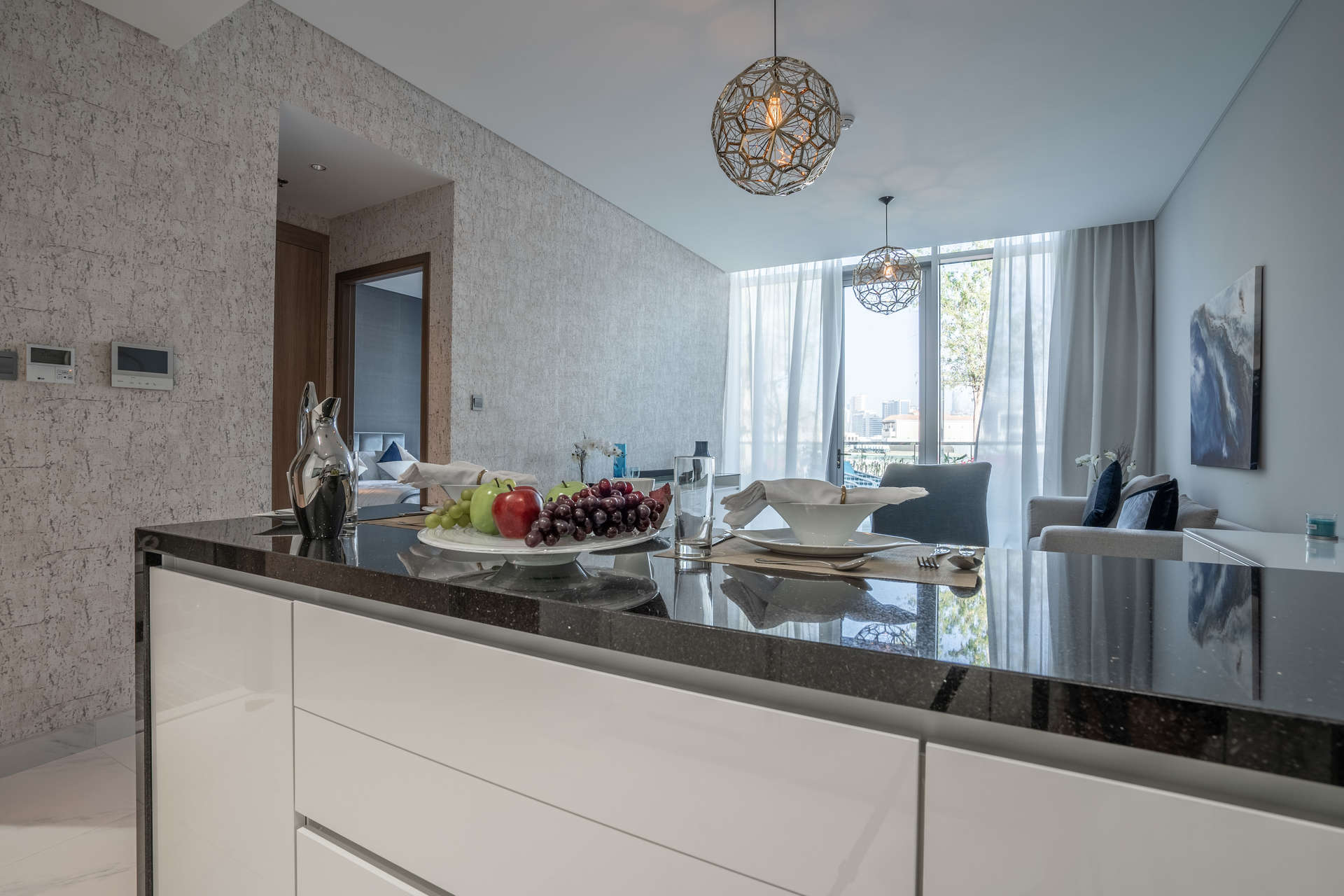 Modern kitchen and living area in Orb Tower Apartment, District One Residences, Dubai