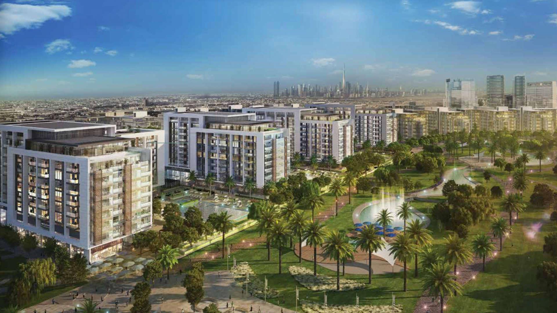 Dubai Hills Estate Park Field view with modern apartments and lush green spaces at dusk