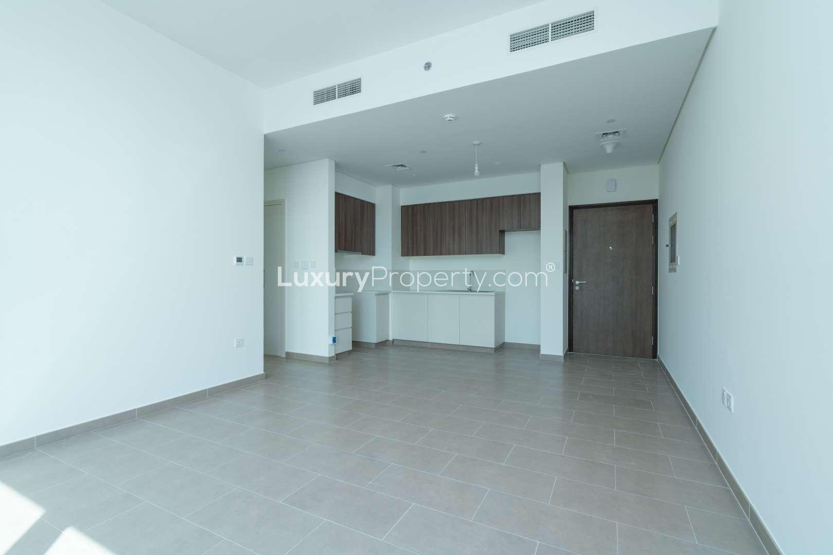High-floor apartment interior with balcony and city views in Dubai Hills Estate