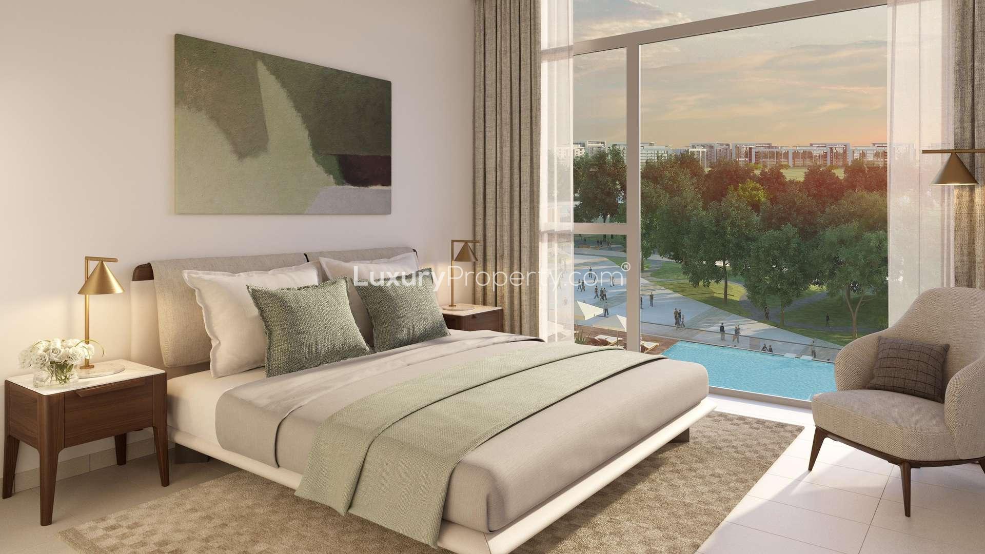 Outdoor seating area at Park Ridge, Dubai Hills Estate apartment complex with lush greenery