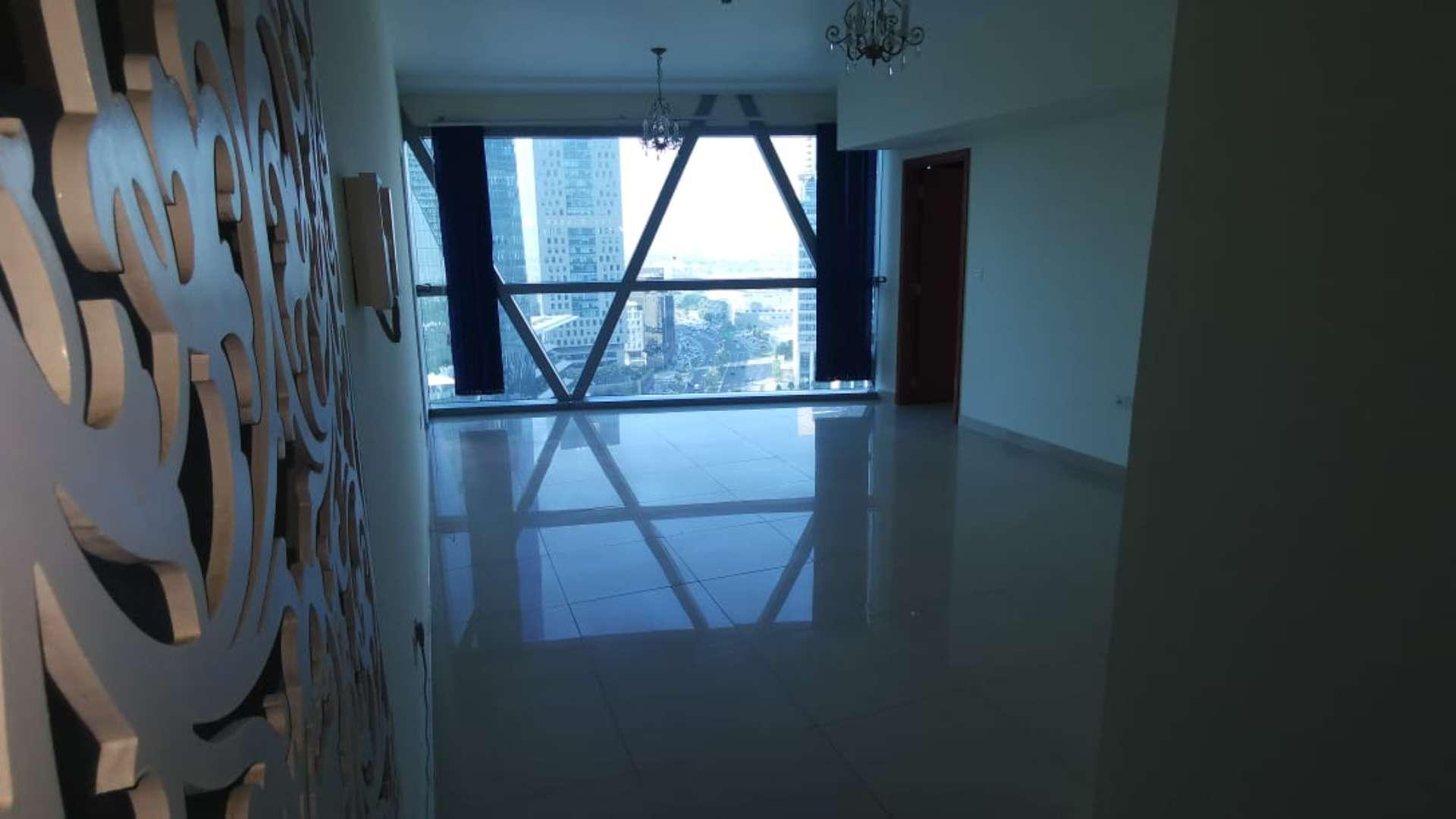 Bedroom with modern decor, large bed, and balcony view in Park Towers apartment, DIFC