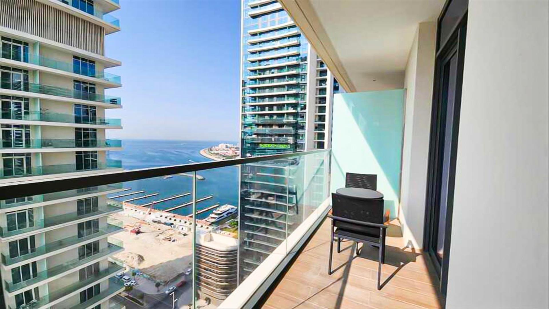 Stylish living room in Dubai Harbour apartment with modern furniture and large windows