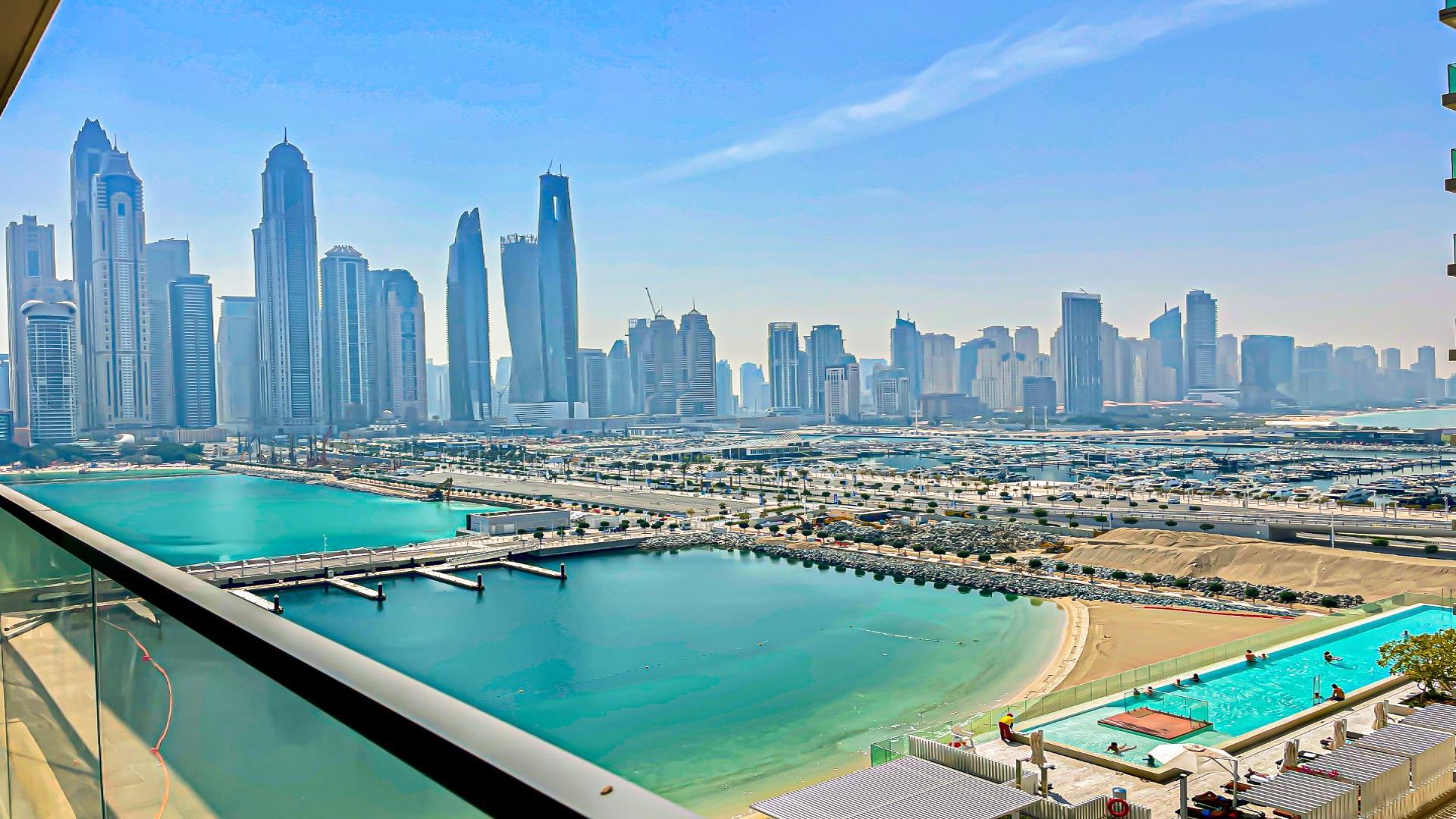 Oceanfront view from Emaar Beachfront apartment in Dubai Harbour, showcasing marina and skyline