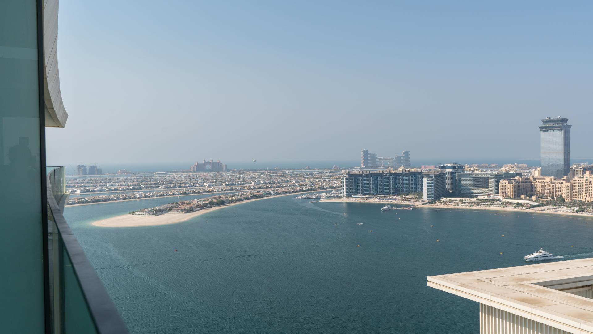 High-floor apartment pool view with sun loungers at Emaar Beachfront, Dubai Harbour